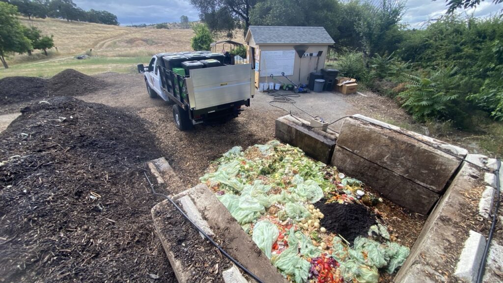 Compost bay with organic material and pickup truck