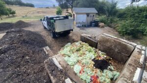 Compost bay with organic material and pickup truck